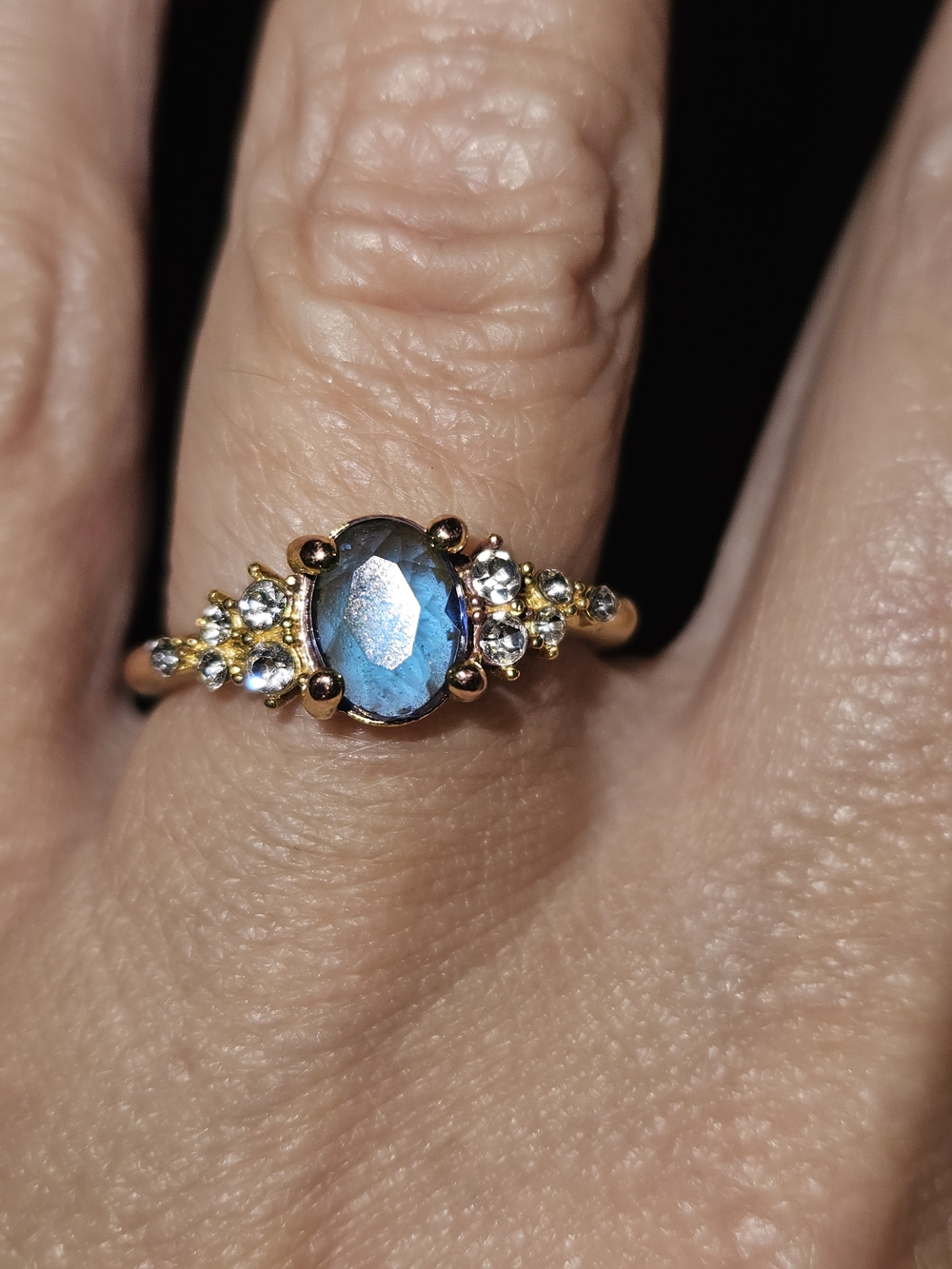 Gold Ring with Blue Oval Gemstone and Accent Stones